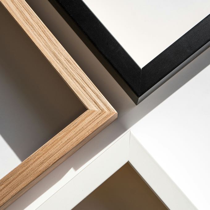 Corner details of wood, black and white picture frames